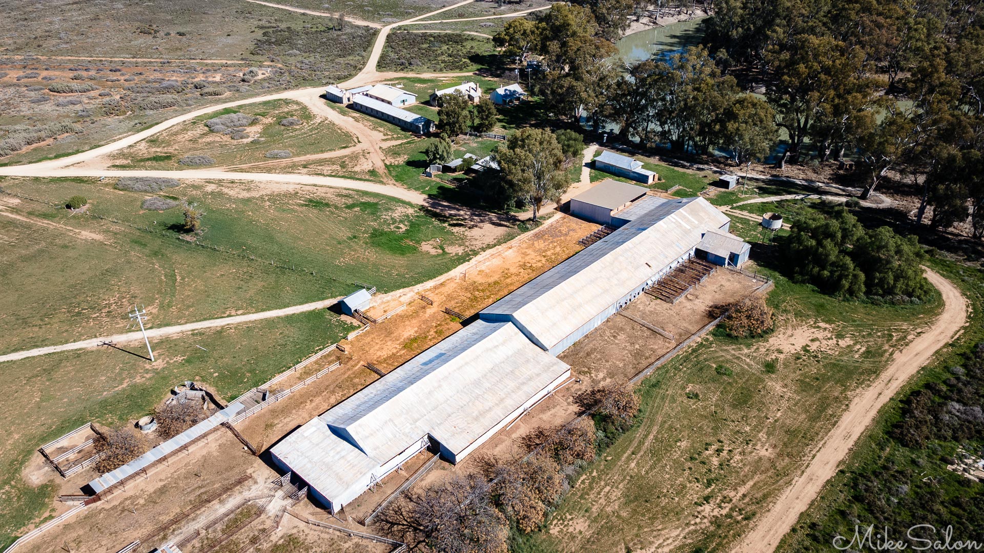 An old woolshed kept in magnificent condition in the care of the NPWS. The Murrumbidgee River curves around at the top right. The buildings to the left include mess huts, washrooms and quarters for experts, shearers, woolclassers. [0060]