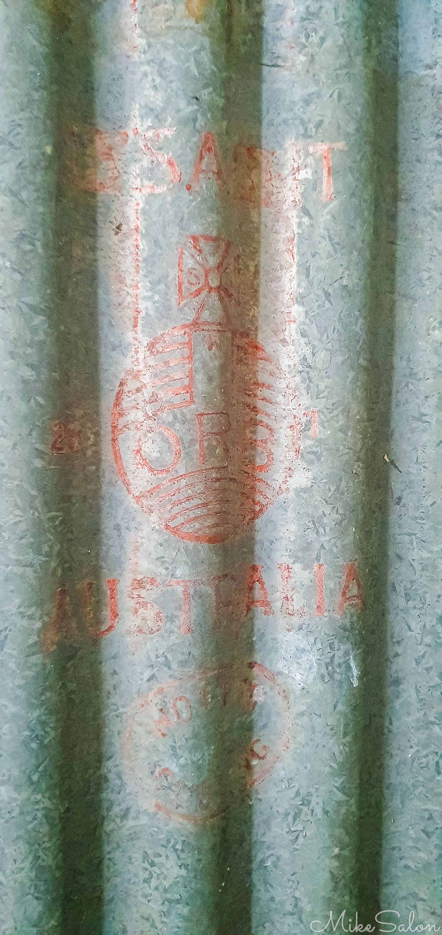 A faeded Lysaght Red Orb brand on an old corrugated iron wall. [2201]