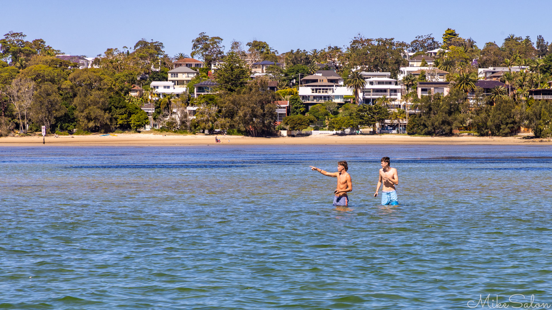 Two boys paddling in shallow waters in Port Hacking. [6511]