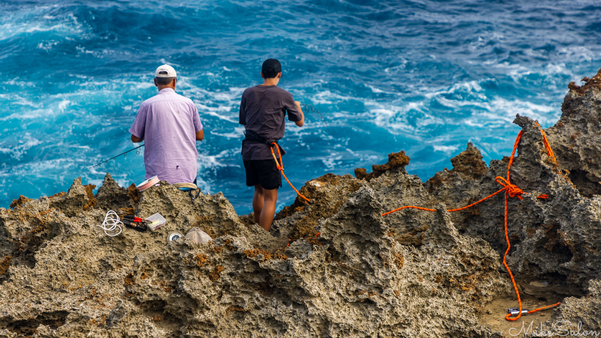 Fishermen near the Blowholes, highlighing the jagged rocks. [9895]