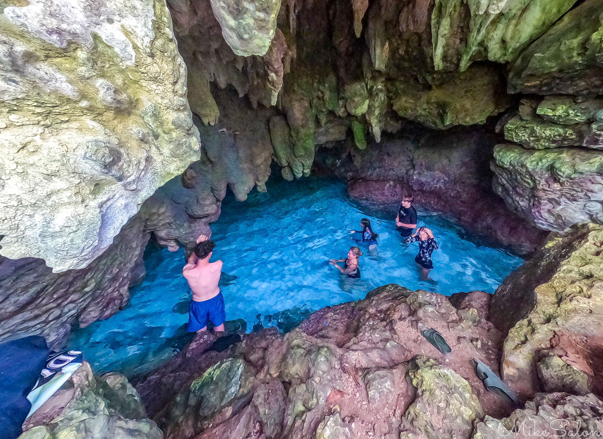Bathers in The Grotto, showing algae coloured limestone. [1321]
