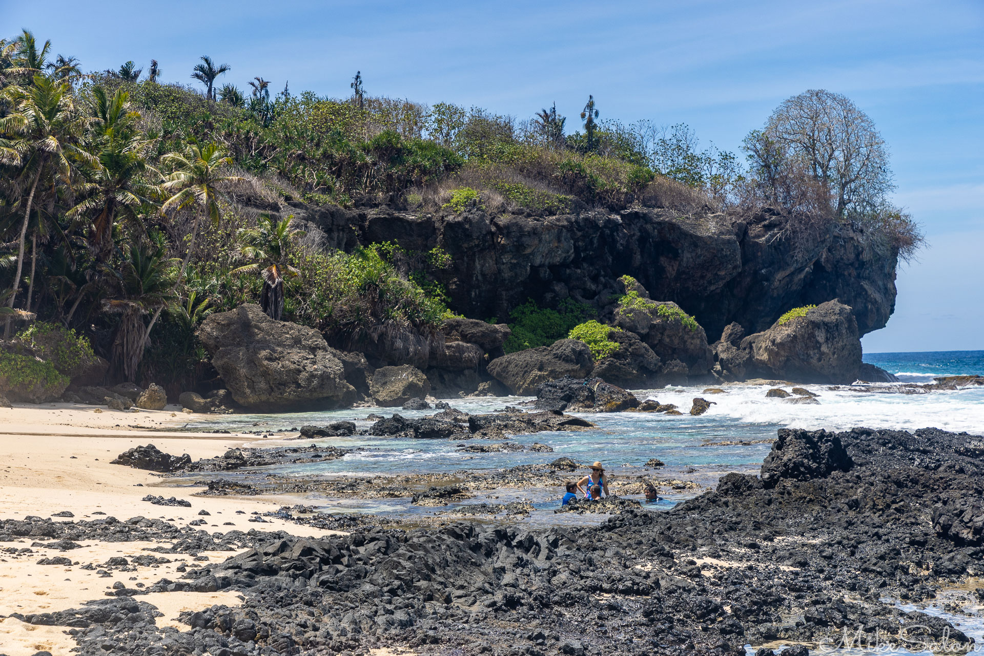 Dolly Beach, showing some people in a rock pool. [9931]
