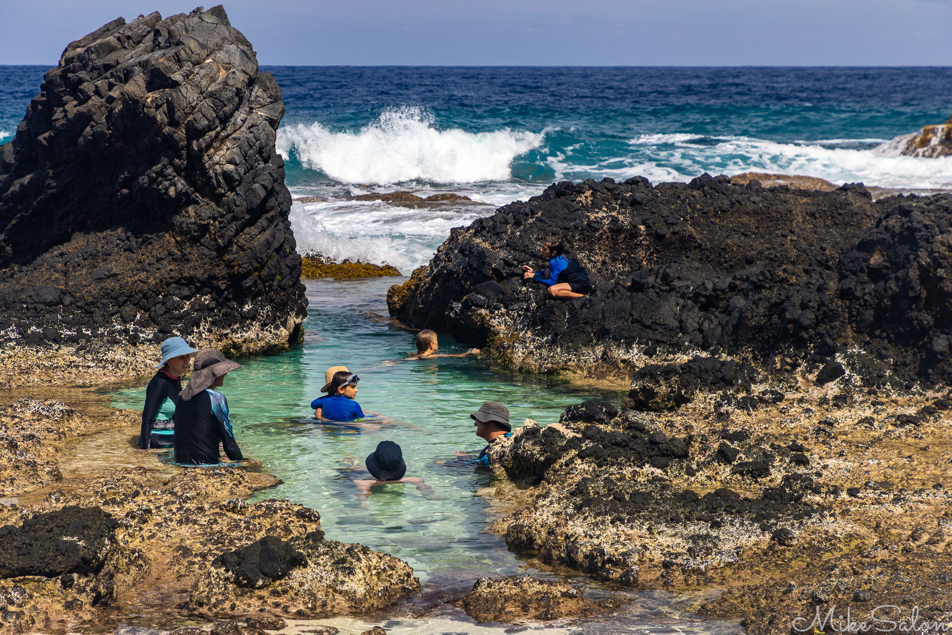 Dolly Beach, showing some people in a rock pool. [9955]