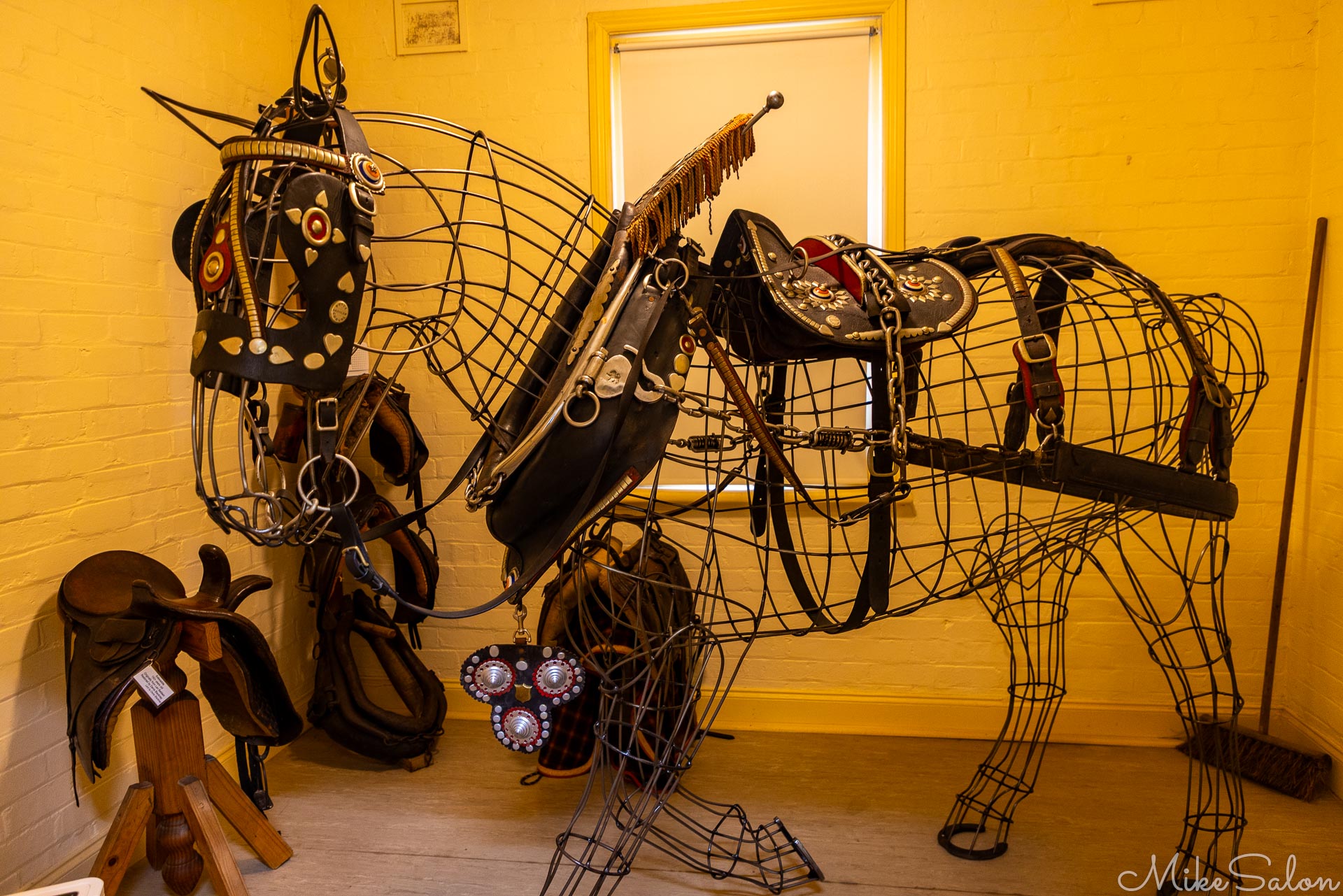 At the Cootamnundra Heritage Centre, a Clydesdale`s fine harness exhibited on a wire frame. Note the broom for sweeping up manure![5094]