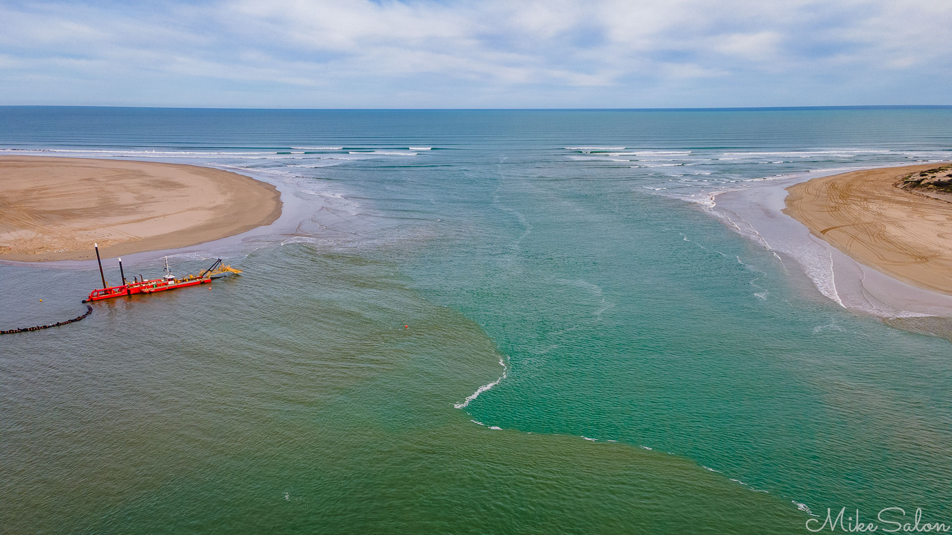 Aerial view of Murray River Mouth showing the sand dredge. [0002]