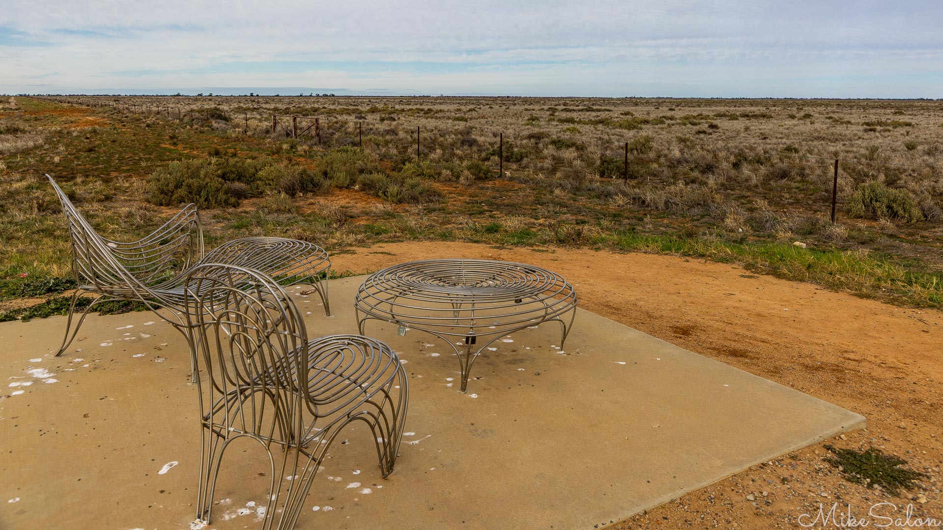 Chairs looking over empty plains at a sunset viewing spot. [1977]