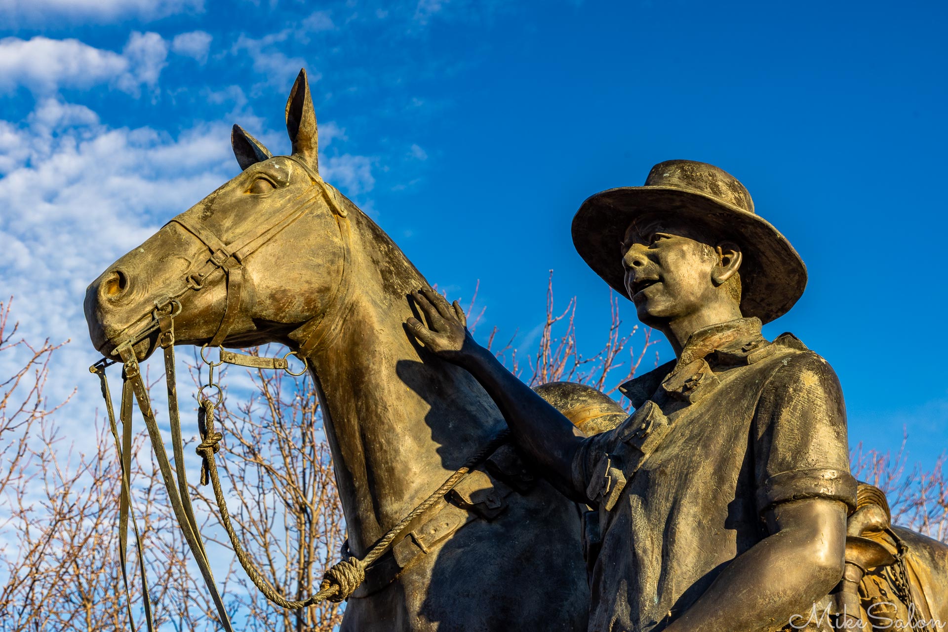 Statue commemorating the WW1 Battle of Beersheba, features a digger and his horse, against a blue sky. [1932]