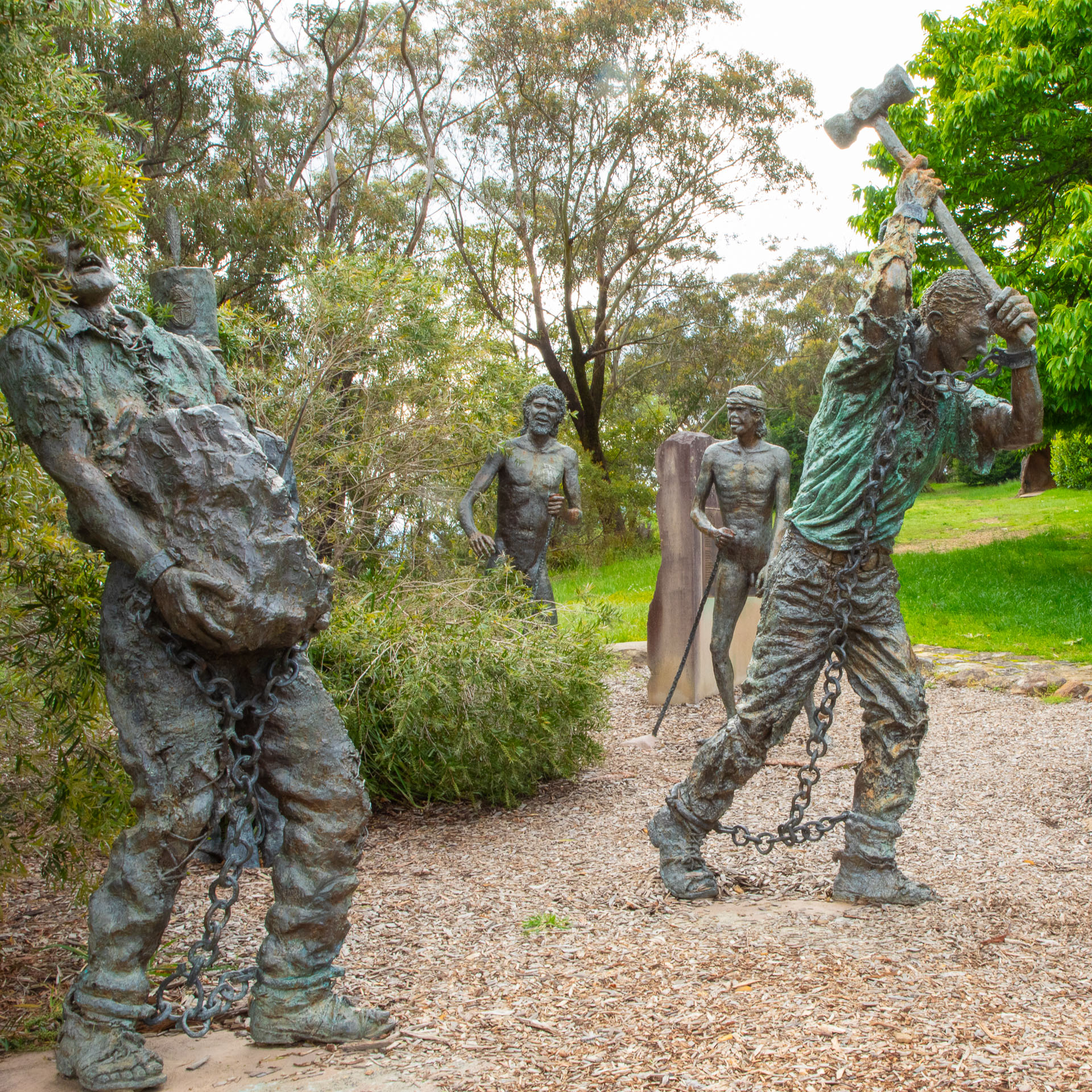 Impressive statue, the `Road Builders Memorial` in Katoomba, featuring two chained convict laborers, and two Aborigines looking on. [8661]
