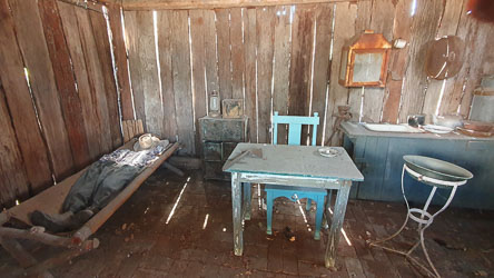 Simulated interior of a preserved or restored slab hut in Merriwa. These single room dwellings were common in colonial times in Australia. [5809]