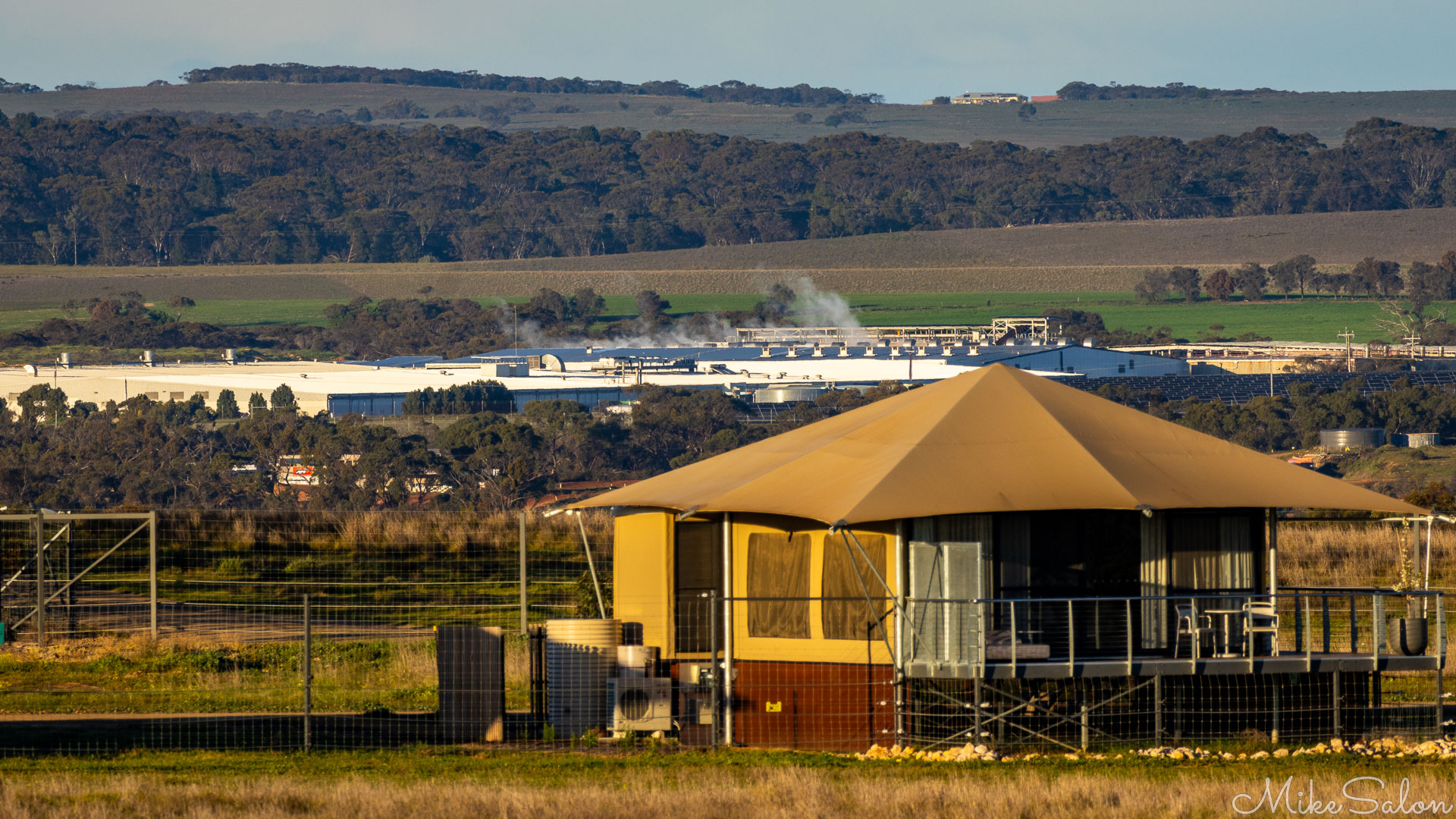 Factory seemingly just outside the Zoo boundary, seen behind a luxury tent. [2588]