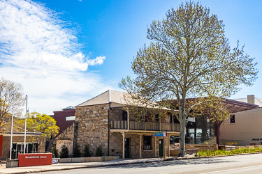 From left in Bridge St Muswellbrook, the town library, then Weidmann Cottage, and the University of Newcastle`s Donald Horne Building. [5568]