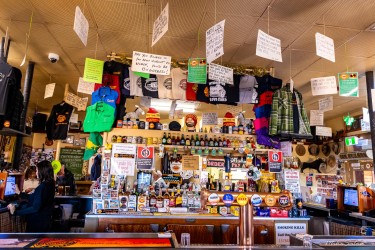 Interior of Silverton Hotel bar with merchandise, hanging items, and counter filled with goods.