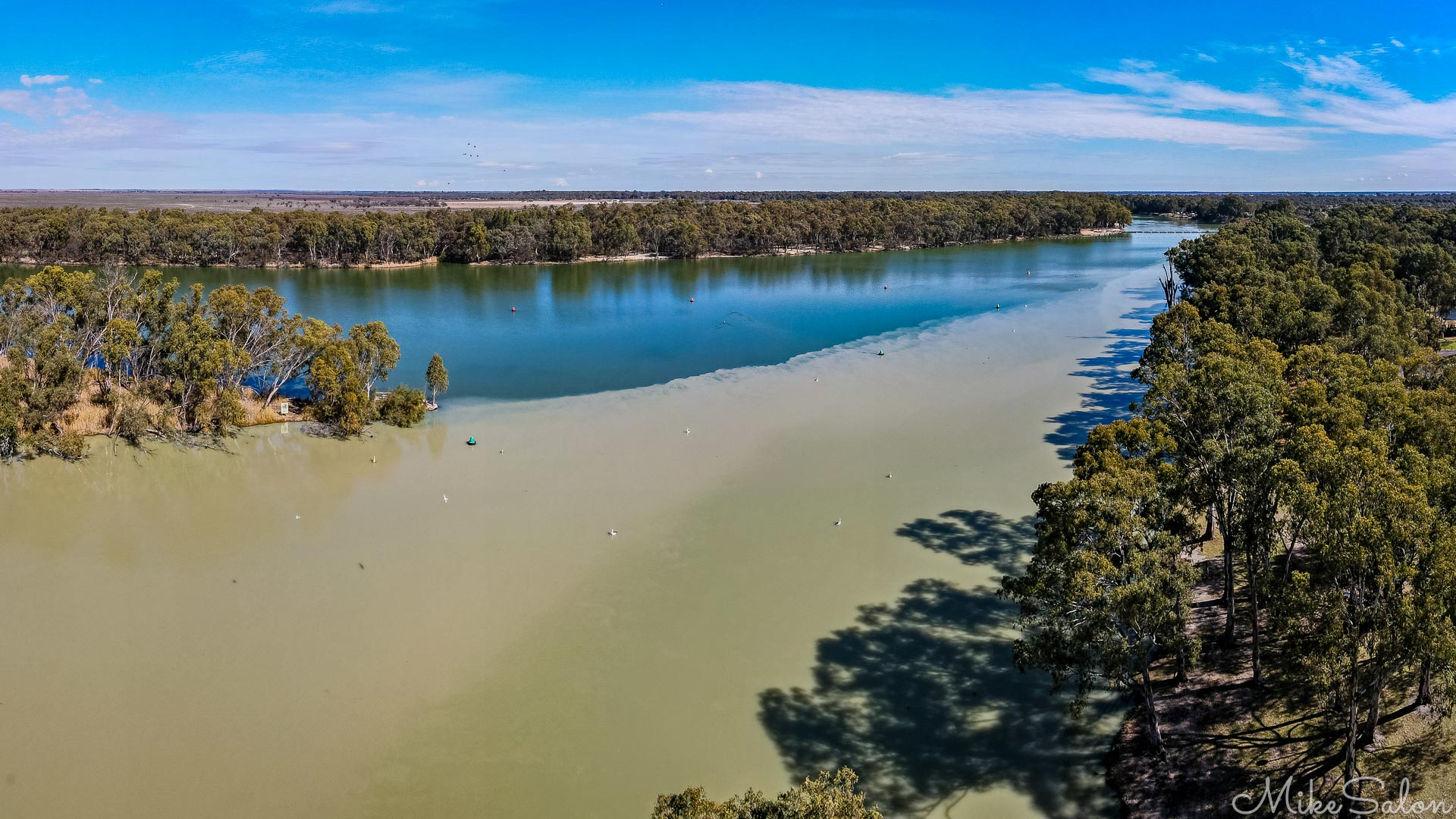  Aerial photo of river junction with visible colour divide and surrounding vegetation.