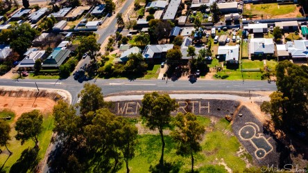 Overhead view of park with tractor monument and "Wentworth" lettering visible on ground.