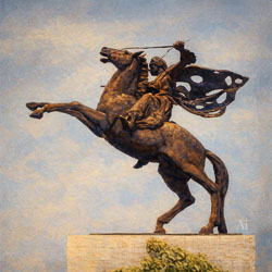 Bronze equestrian statue of Arjuna Wijaya in Jakarta, showing a warrior on a rearing horse with a flowing perforated cloak, atop a stone pedestal under a clear blue sky.