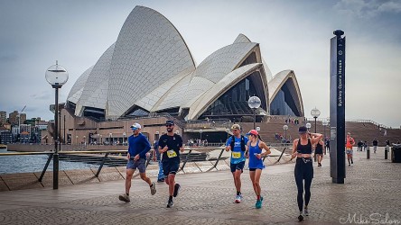 Bondi‑to‑Manly Ultra runners passing the Sydney Opera House along Circular Quay promenade, with the Opera House