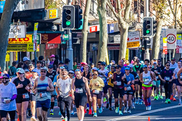 Runners tackle the steady rise toward Taylor Square around the 18 km mark, working hard up the Oxford Street hill as Darlinghurst locals cheer them on in the morning sun. [3917]