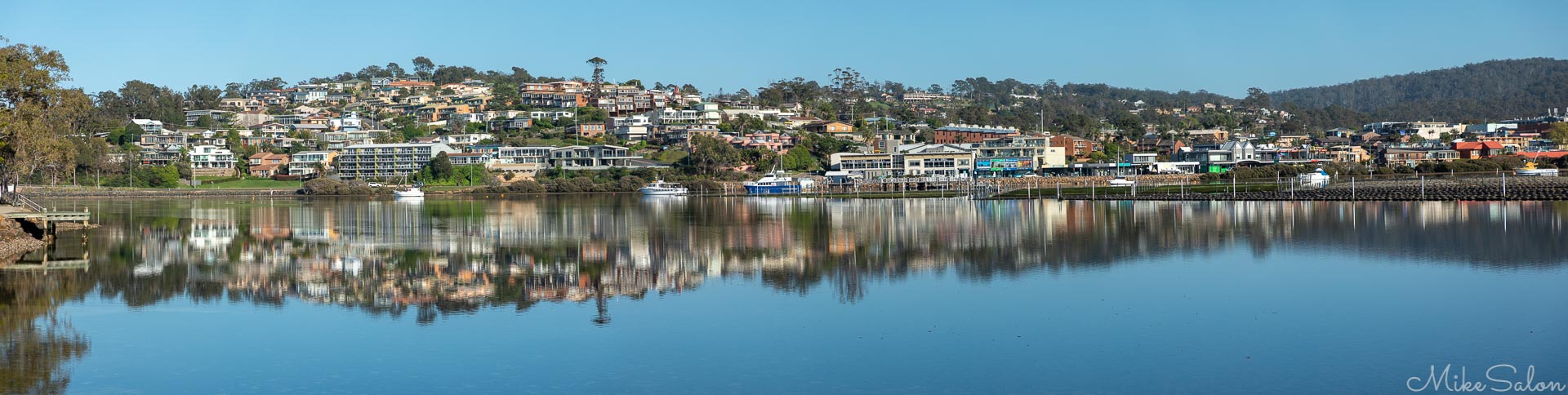 Merimbula : A crisp dawn on a still day reflects Merimbula town in southern NSW. (_D0A7198-Pano.jpg)<br>Camera: Canon EOS 5D Mark IV