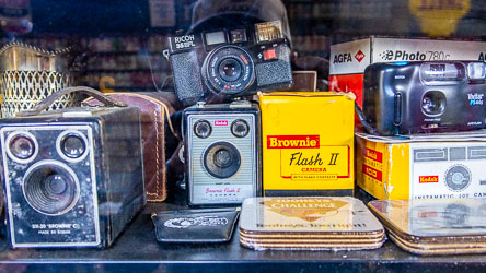 Display of vintage cameras including Kodak Brownie C, Brownie Flash II, Ricoh 35 ZF, and Vivitar PS44 with original boxes and accessories at the Great Aussie Beer Shed.