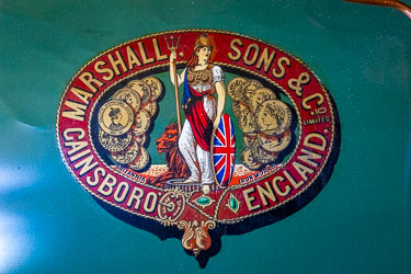 Decorative Marshall & Sons boiler plaque showing Britannia with trident, Union Jack shield, and gold medallions, painted on green background aboard the P.S. Pevensey.