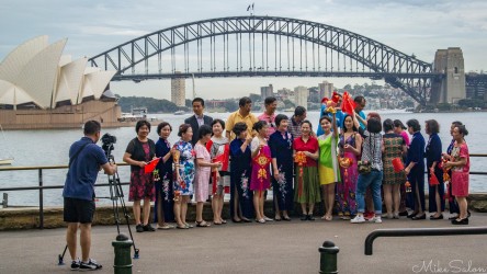 Colourfully dressed tour group posing for a photo at Sydney